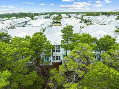 an aerial view of a white house with trees at Serenity Sunset in Inlet Beach