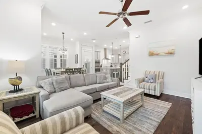 a living room with a couch and a table at Serenity Sunset in Inlet Beach