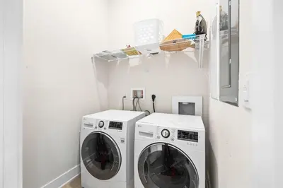 a laundry room with two washing machines in it at Coastal Beauty in Inlet Beach