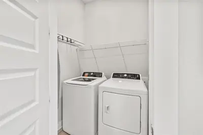 a laundry room with a washer and dryer at Isle be Back in Inlet Beach