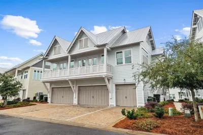 a large white house with a garage at Isle be Back in Inlet Beach