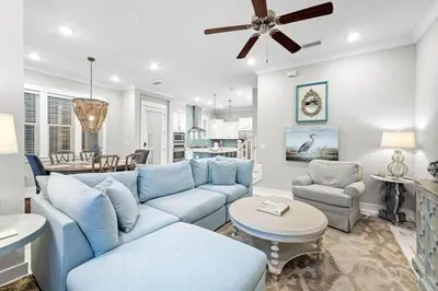 a living room with a blue couch and a table at Endless Summer in Inlet Beach