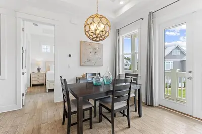 a dining room with a black table and chairs at Just Add Water in Inlet Beach