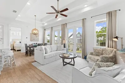 a living room with two couches and a table at Just Add Water in Inlet Beach
