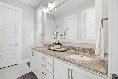 a white bathroom with a sink and a mirror at The Tipsy Turtle in Inlet Beach