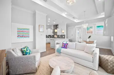 a living room with a white couch and a table at Mermaid Day in Inlet Beach