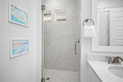 a white bathroom with a shower and a sink at Mermaid Day in Inlet Beach