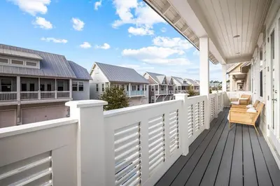 a porch with white railings on a house at Mermaid Day in Inlet Beach