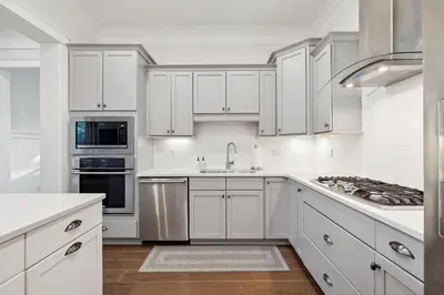 a white kitchen with white cabinets and a sink at Selah by the Sea in Inlet Beach