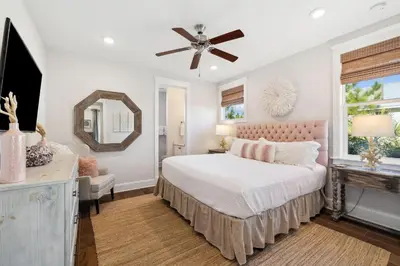 a bedroom with a bed and a ceiling fan at Selah by the Sea in Inlet Beach