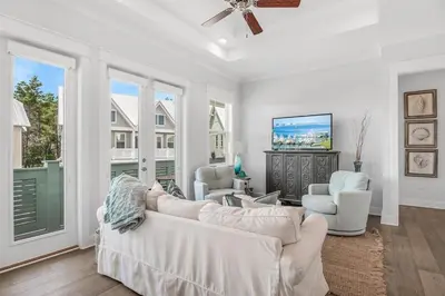 a living room with two white couches and a tv at No Worries, Beach Happy in Inlet Beach