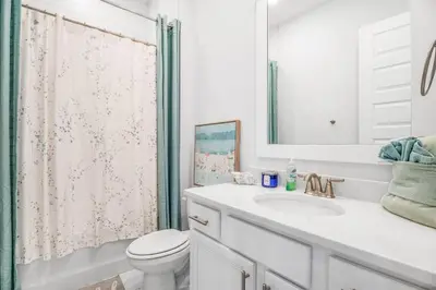 a white bathroom with a toilet and a sink at No Worries, Beach Happy in Inlet Beach