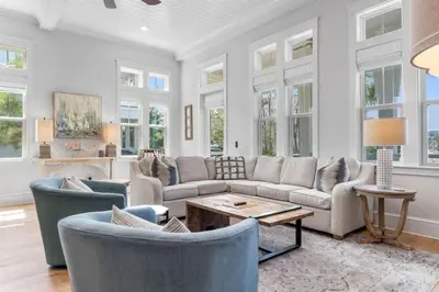 a living room with a couch and chairs and a table at Sunset Key in Inlet Beach