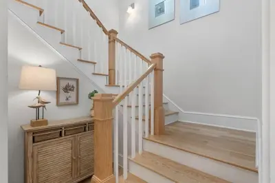 a staircase in a home with white walls at Sunset Key in Inlet Beach