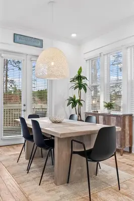 a dining room with a large wooden table and chairs at Sunkissed on 30A in Inlet Beach