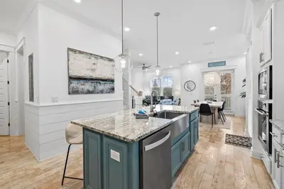 a kitchen with blue cabinets and a counter top at Sunkissed on 30A in Inlet Beach