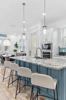 a kitchen with a large island with stools at Sunkissed on 30A in Inlet Beach