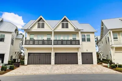 a large white house with two garage doors at Sunkissed on 30A in Inlet Beach
