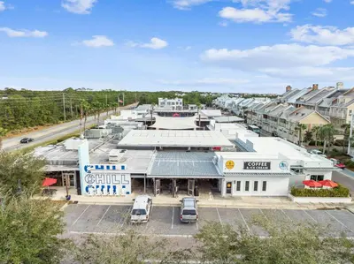 an aerial view of a building with cars parked in a parking lot at Sunkissed on 30A in Inlet Beach