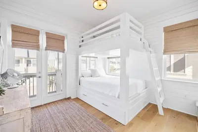 a white bedroom with a white bed and windows at Lovely Day on 30A in Inlet Beach