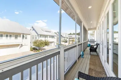 a large porch with a view of the ocean at Lovely Day on 30A in Inlet Beach