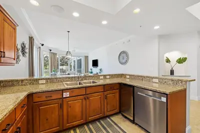 a kitchen with a sink and a dishwasher at The Alexander in Seacrest