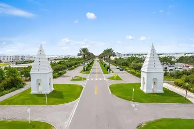 an empty road with white structures in the middle of a street at The Alexander in Seacrest