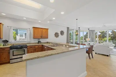 a kitchen with a counter top and a living room at The Alexander in Seacrest