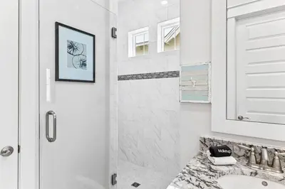 a white bathroom with a shower and a sink at Sea Ya Soon in Inlet Beach