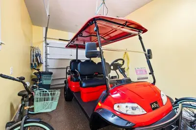 a golf cart with a bike parked next to it at Sea Ya Soon in Inlet Beach