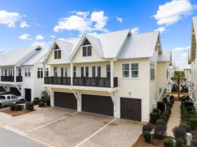 a white house with a metal roof at Sea Ya Soon in Inlet Beach