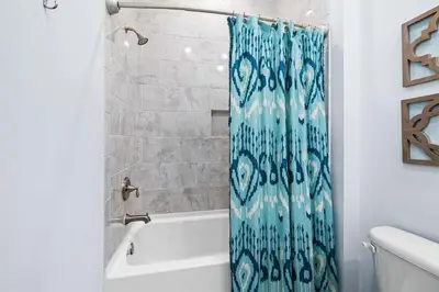 a bathroom with a tub and a shower curtain at White Sand Dreamin' in Inlet Beach