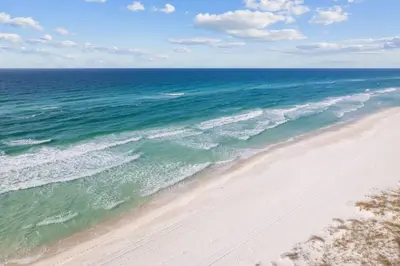 an aerial view of a beach with the ocean at White Sand Dreamin' in Inlet Beach