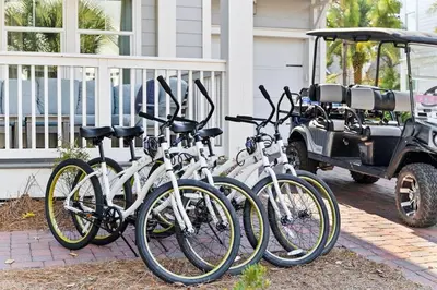a group of bikes parked next to a golf cart at It's a Shore Thing in Inlet Beach