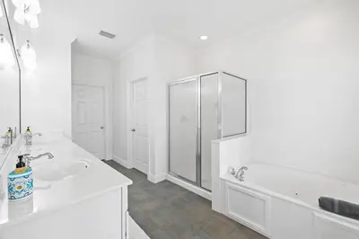 a white bathroom with a tub and a sink at A Lovely Stay on 30A in Seacrest