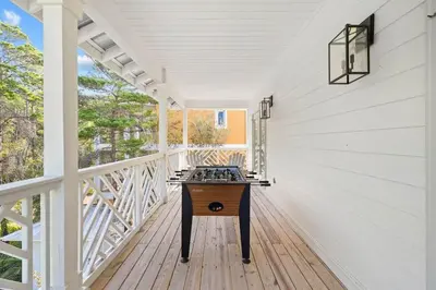 a white porch with a table on it at A Lovely Stay on 30A in Seacrest
