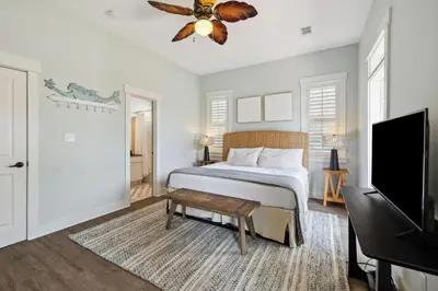 a bedroom with a bed and a flat screen tv at Resting Beach Place in Inlet Beach