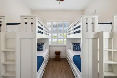 two bunk beds in a room with a window at Resting Beach Place in Inlet Beach