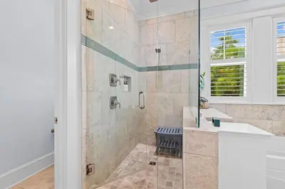 a white bathroom with a shower and a sink at Sol Mates in Inlet Beach