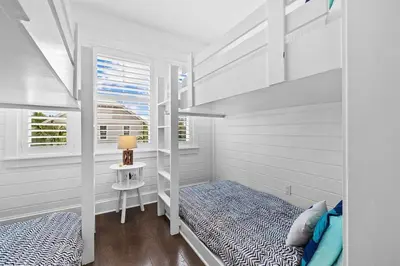 a bedroom with two bunk beds and a table at Sol Mates in Inlet Beach