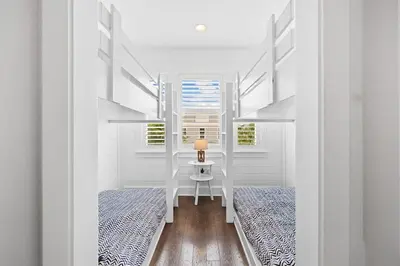 a bedroom with two beds and a lamp on a table at Sol Mates in Inlet Beach