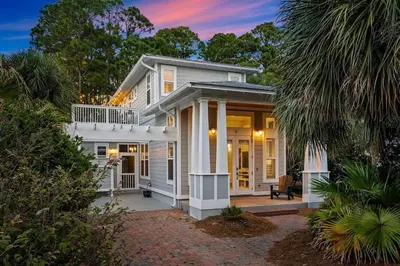 a white house with a front porch with a porch at Sweet Bay on 30A in Seagrove Beach