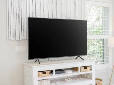 a flat screen tv sitting on top of a white entertainment center at Sweet Bay on 30A in Seagrove Beach