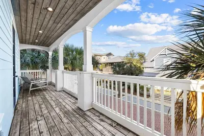 a porch with white railings and a view of the ocean at Southern Comfort in Seacrest