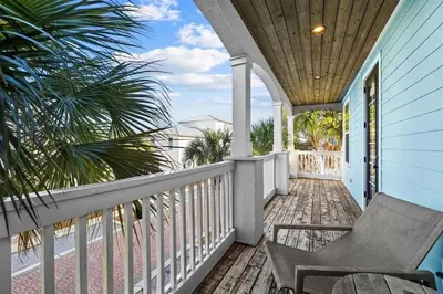 a porch with a chair and a view of the ocean at Southern Comfort in Seacrest