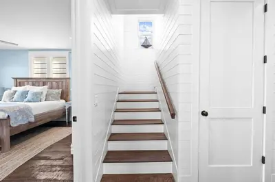 a stairway leading to a bedroom with a bed at Southern Comfort in Seacrest