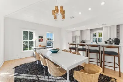 a white kitchen with a white table and chairs at The Last Waltz in Seacrest