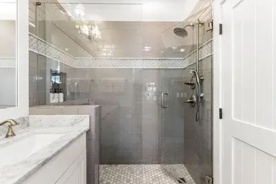 a white bathroom with a shower and a sink at The Last Waltz in Seacrest