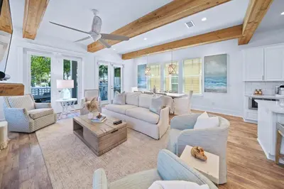 a living room with white furniture and a ceiling fan at Villa Bianca in Seacrest