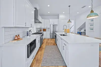 a kitchen with white cabinets and white counter tops at Villa Bianca in Seacrest